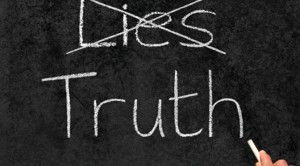 Crossing out Lies and writing Truth on a blackboard.