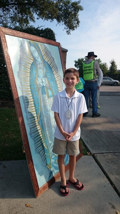 Max praying on the sidewalk with an image of Our Lady of Guadalupe. Photo couresty of the Volanski family.